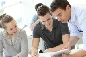 Teacher helping students with assignment